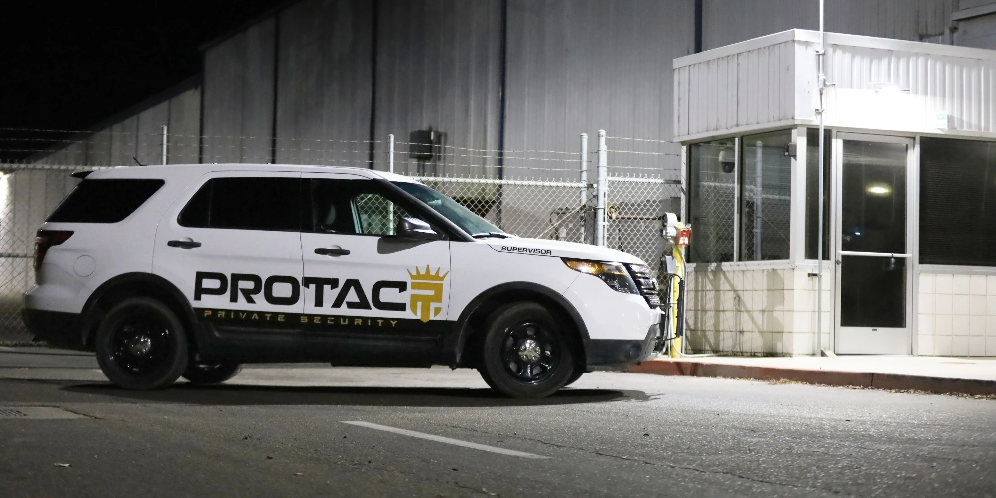 protac security car in front of industrial building at night